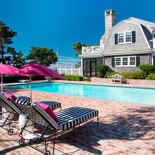 Mid-sized victorian side yard rectangular pool in Boston with a pool house and brick pavers.