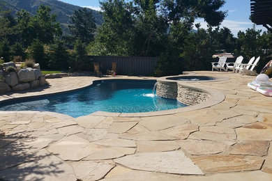 Mid-sized elegant backyard concrete paver and custom-shaped natural pool photo in Salt Lake City