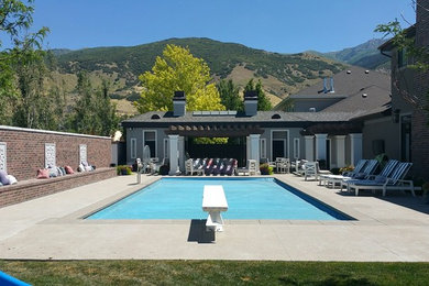 Inspiration for a mid-sized timeless backyard concrete paver and custom-shaped natural pool remodel in Salt Lake City