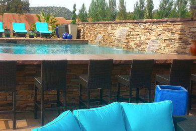 Example of a mid-sized trendy backyard tile and rectangular lap pool fountain design in Phoenix