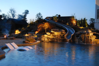 Example of a large classic backyard stone and custom-shaped natural water slide design in DC Metro
