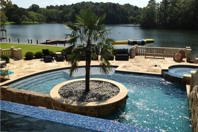 Pool fountain - mid-sized traditional backyard infinity pool fountain idea in Little Rock