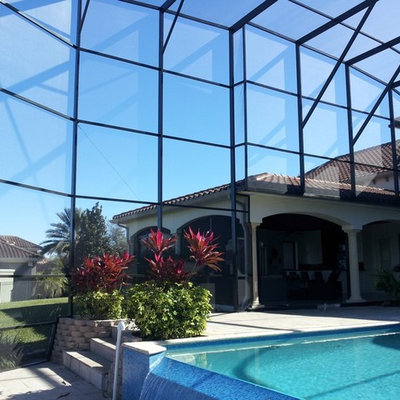 Large trendy backyard concrete and rectangular aboveground pool house photo in Orlando