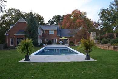Example of a mid-sized classic backyard rectangular and concrete paver lap pool design in Atlanta