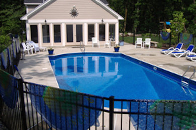 Design ideas for a large back custom shaped swimming pool in Boston.