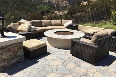 This is an example of a large mediterranean back patio in Los Angeles with concrete paving.