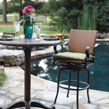 Outdoor bar stool and pedestal table made of resin wicker and wrought iron