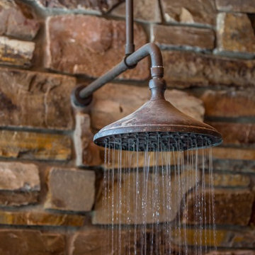 Outdoor heated shower adjoins hot tub and sauna area