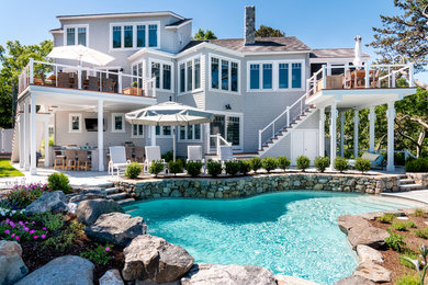 This is an example of a nautical back custom shaped swimming pool in Boston.