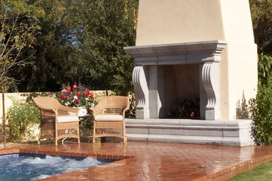 Hot tub - traditional backyard brick and custom-shaped hot tub idea in Albuquerque