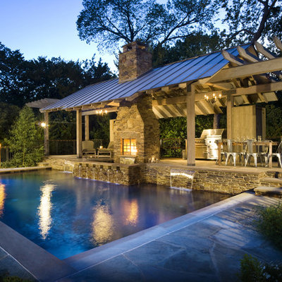 Inspiration for a rustic rectangular pool house remodel in Dallas