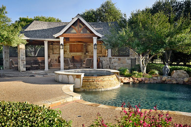 Pool house - large contemporary backyard stamped concrete and custom-shaped lap pool house idea in Dallas