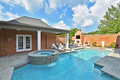 Pool fountain - modern backyard stone pool fountain idea in Charlotte