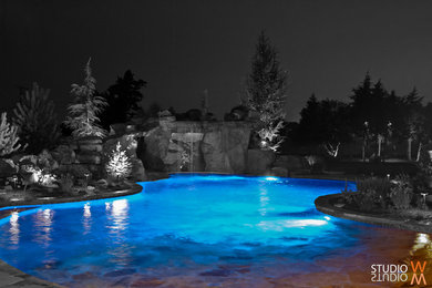 Pool fountain - large traditional backyard brick and custom-shaped lap pool fountain idea in Oklahoma City
