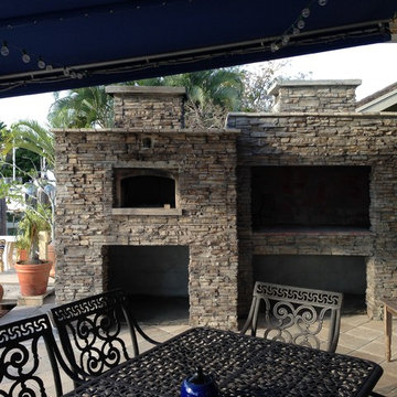 Outdoor pizza oven and fireplace by the pool