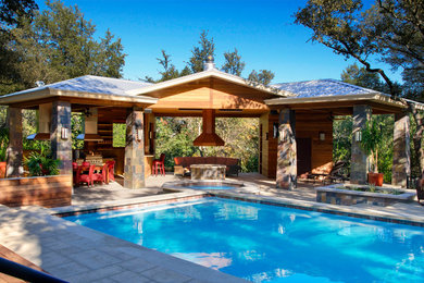 Example of a mid-sized classic backyard stone and rectangular lap hot tub design in Austin