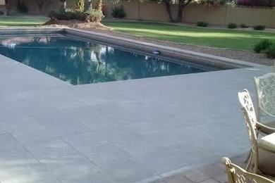 Inspiration for a large tropical backyard stamped concrete and rectangular lap pool remodel in Phoenix