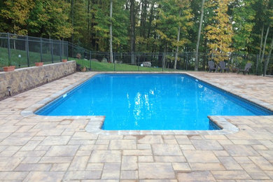 Inspiration for a mid-sized backyard brick and rectangular pool remodel in Bridgeport