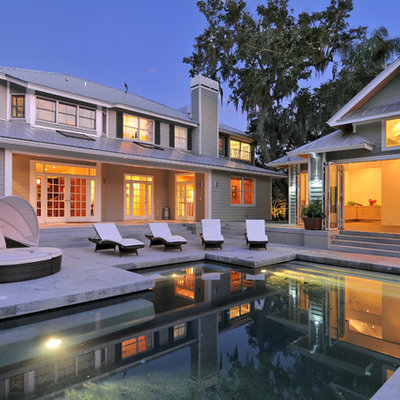 Example of a small trendy backyard concrete and rectangular pool house design in Tampa