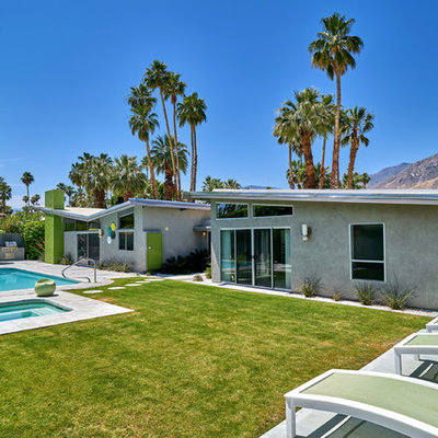 Inspiration for a large 1960s backyard rectangular natural pool remodel in Other