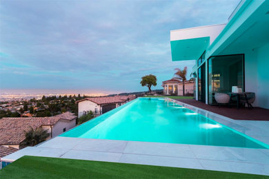 Großer, Gefliester Moderner Infinity-Pool hinter dem Haus in rechteckiger Form in Orange County