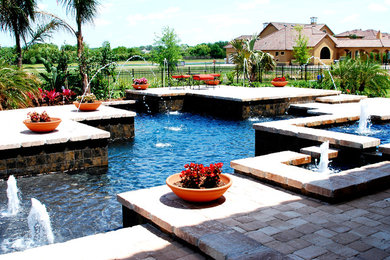 Inspiration for a large mediterranean back rectangular lengths hot tub in Orlando with brick paving.