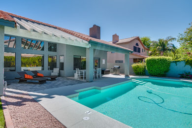 Example of a mid-sized minimalist backyard rectangular natural pool design in Phoenix