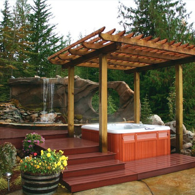 Large island style backyard rectangular aboveground hot tub photo in Boise with decking