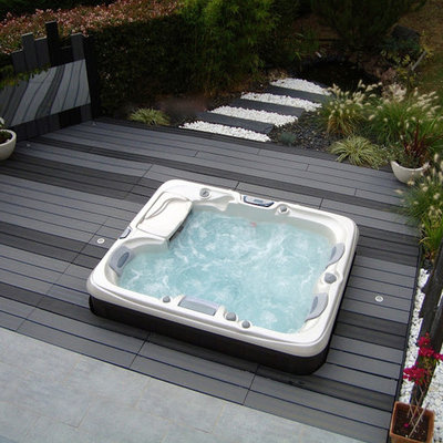 Large trendy backyard rectangular aboveground hot tub photo in Los Angeles with decking