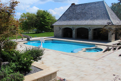 Huge elegant backyard concrete paver and rectangular natural pool fountain photo in Indianapolis