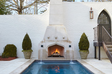 Inspiration for a mid-sized mediterranean backyard concrete paver and rectangular pool fountain remodel in Birmingham