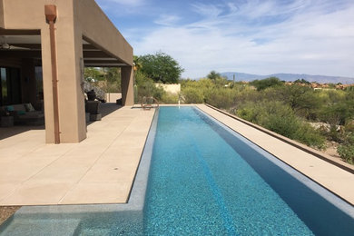 Huge trendy backyard concrete paver and custom-shaped infinity pool photo in Phoenix