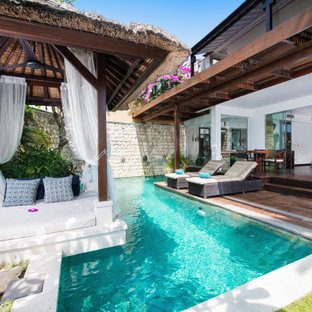 Photo of a tropical custom-shaped pool in Gold Coast - Tweed with decking.