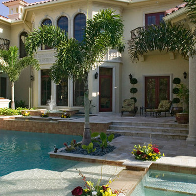 Hot tub - mid-sized mediterranean backyard tile and custom-shaped lap hot tub idea in Miami