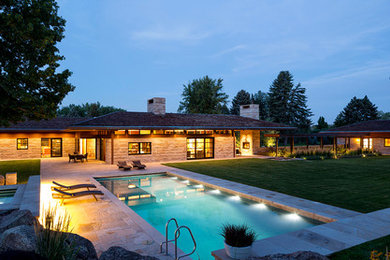 Example of a large backyard stone and rectangular natural hot tub design in Denver