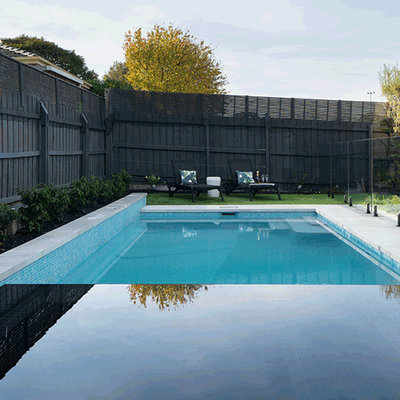 Example of a large minimalist backyard concrete paver and rectangular lap hot tub design in Melbourne