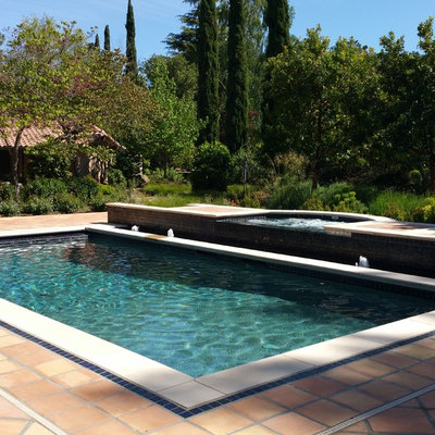 Pool fountain - mid-sized mediterranean backyard tile and rectangular lap pool fountain idea in San Francisco