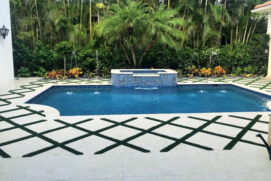Mid-sized tuscan courtyard stone and rectangular pool photo in Miami