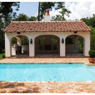 Large mediterranean backyard rectangular lap pool in Other with brick pavers and a hot tub.
