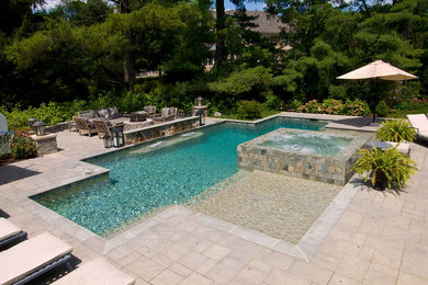 Pool and Spa with 360 degree spa spillover, two sun shelfs, raised stone wall wi