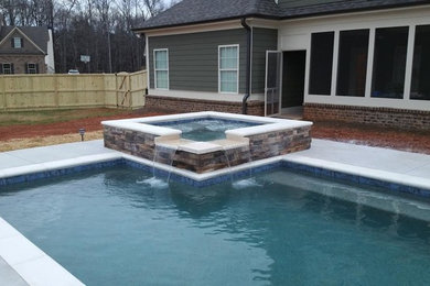 Inspiration for a mid-sized transitional backyard concrete and custom-shaped natural hot tub remodel in Atlanta