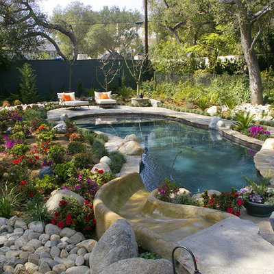 Inspiration for a large timeless backyard stone and custom-shaped water slide remodel in Los Angeles