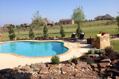 Inspiration for a mid-sized backyard stone pool remodel in Dallas