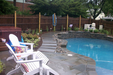 Large transitional backyard stone and custom-shaped natural pool photo in Baltimore