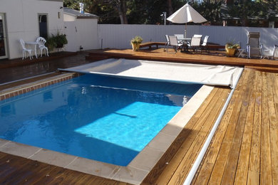 Inspiration for a back rectangular swimming pool in Denver with a pool house and decking.