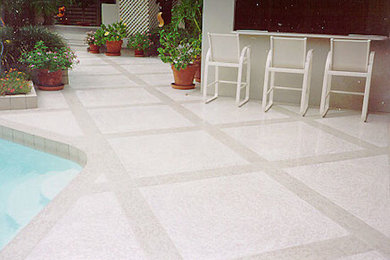 Example of a large backyard concrete paver patio design in Grand Rapids