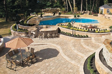 Inspiration for a huge transitional backyard stone and custom-shaped hot tub remodel in DC Metro
