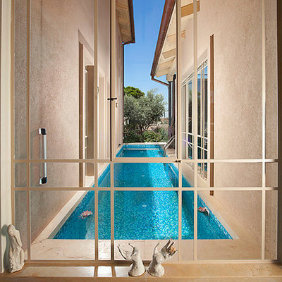 Inspiration for a contemporary courtyard lap pool remodel in Other