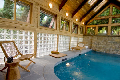 Inspiration for a large zen indoor stone and custom-shaped pool house remodel in Boston