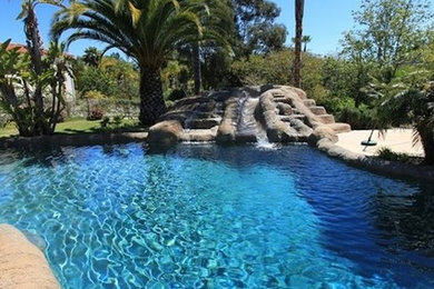 Inspiration for a large backyard concrete and custom-shaped water slide remodel in San Diego